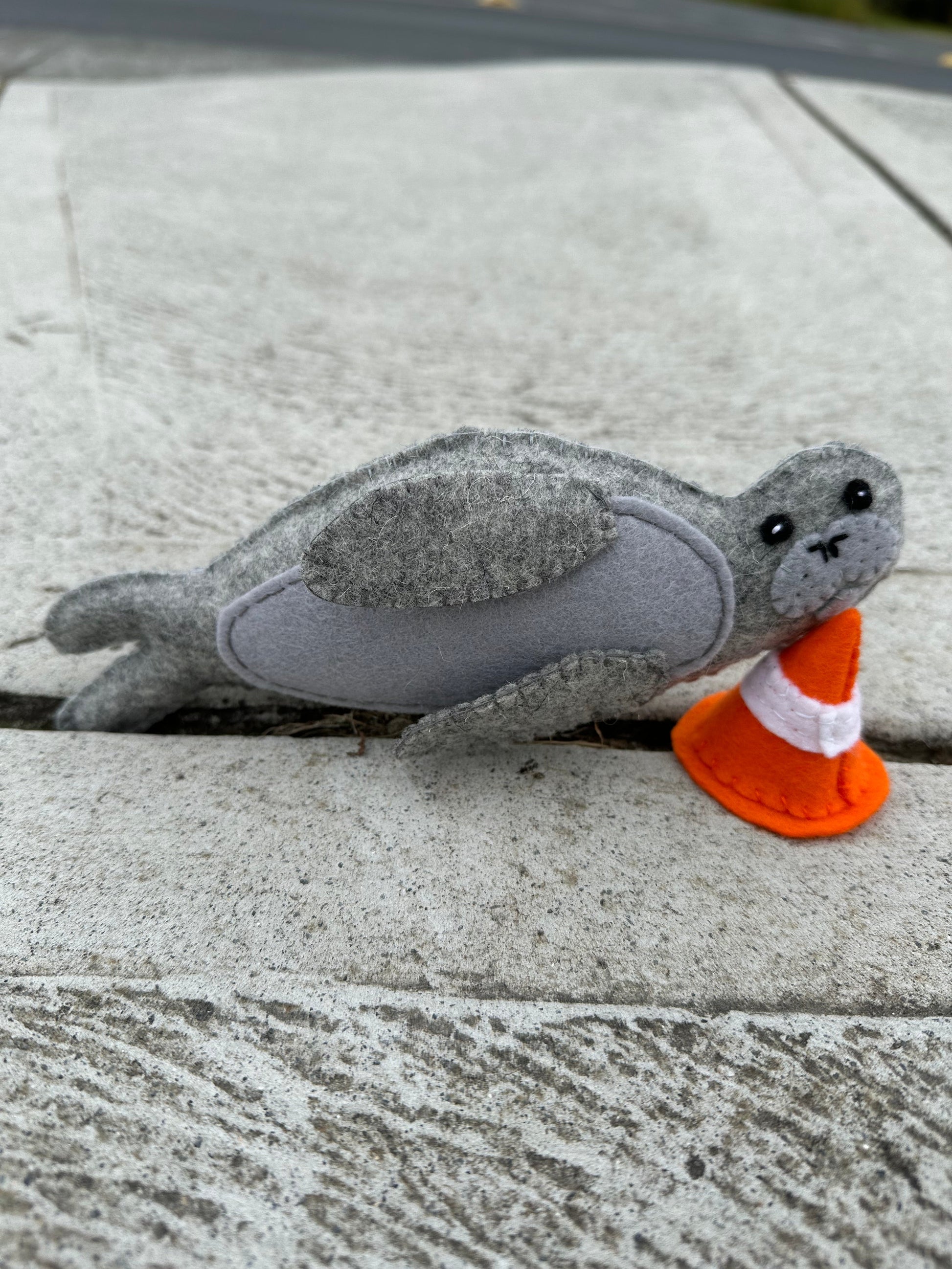 Neil the Seal soft toy with traffic cone made from wool feltNeil the Seal, a loveable Tasmanian character! This soft toy comes with his signature traffic cone, bringing a smile to anyone's face. Made from wool felt.Tasmanian Softies