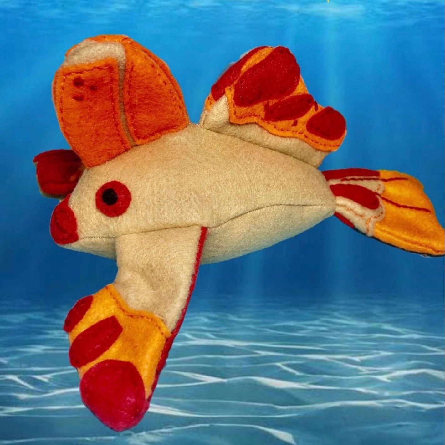 Handfish soft toy handmade in Felt made in TasmaniaThis Handfish plushie is skillfully handmade in Tasmania from wool felt. Its adorable design pays homage to the rare Handfish species and is filled with recycled plastic bottles, making it a fun and eco-c