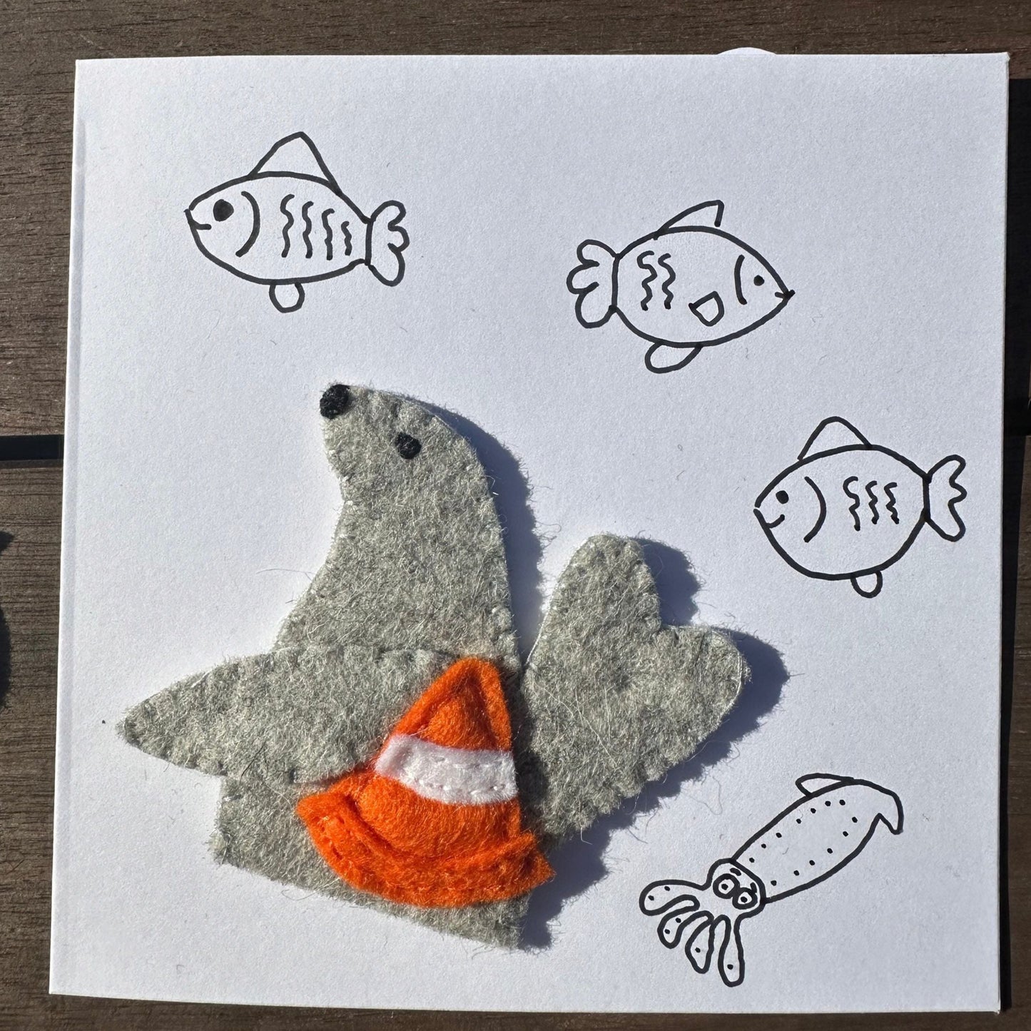 Neil the Seal finger puppet with greeting cardIntroducing Neil the Seal: a finger puppet made with wool felt! Handcrafted in Tasmania, Neil comes with a greeting card for added cuteness. What a playful addition to your puppet collection!Tasmanian Softies